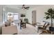 Cozy living room features a ceiling fan, large rug, and an accent chair at 5147 Saint Paul St, Denver, CO 80216