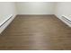 Spacious room featuring hardwood floors, white walls, and clean lines at 5147 Saint Paul St, Denver, CO 80216