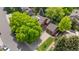 Stunning aerial view of a well-maintained home with a two-car garage, mature trees, and a spacious driveway at 10886 E Crestline Cir, Englewood, CO 80111