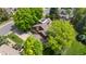 Captivating aerial view of a home surrounded by lush greenery and mature trees offering privacy at 10886 E Crestline Cir, Englewood, CO 80111