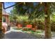 Inviting backyard seating area with a charming patio, lush greenery, and beautiful landscaping at 10886 E Crestline Cir, Englewood, CO 80111