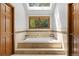 Bright bathroom with a skylight and a luxurious soaking tub, offering a relaxing retreat at 10886 E Crestline Cir, Englewood, CO 80111