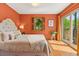 Bright and airy bedroom featuring neutral tones, a decorative window, and access to a private outdoor space at 10886 E Crestline Cir, Englewood, CO 80111