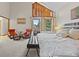 Spacious main bedroom with tall ceilings featuring large windows and a comfortable sitting area at 10886 E Crestline Cir, Englewood, CO 80111