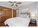 Bright bedroom featuring hardwood floors, a ceiling fan, and a spacious closet at 10886 E Crestline Cir, Englewood, CO 80111