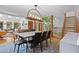 Bright dining room features a modern chandelier, large windows, and unique indoor greenery at 10886 E Crestline Cir, Englewood, CO 80111