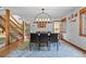 Elegant dining room featuring hardwood floors, modern chandelier, and an open floor plan at 10886 E Crestline Cir, Englewood, CO 80111