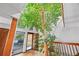 Bright, light-filled foyer with indoor tree and large windows at 10886 E Crestline Cir, Englewood, CO 80111