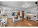 Spacious kitchen featuring white cabinets, granite countertops, and a central island with barstool seating at 10886 E Crestline Cir, Englewood, CO 80111