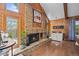 Detailed view of the brick fireplace, wood paneling, and built-in bar in the living room at 10886 E Crestline Cir, Englewood, CO 80111