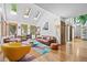Sun-drenched living room with vaulted ceilings, skylights, and hardwood floors at 10886 E Crestline Cir, Englewood, CO 80111