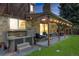 Back patio with a hot tub, outdoor seating and string lights at 10886 E Crestline Cir, Englewood, CO 80111