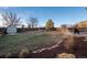 Large, fenced backyard featuring a lawn, stone patio, shed, and landscaping at 3685 Roberts St, Mead, CO 80542