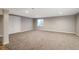 Spacious basement featuring neutral colored walls, carpet, and a window for natural light at 3685 Roberts St, Mead, CO 80542