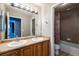 Bathroom with double sink vanity, framed mirror, and a shower-tub combo with tiled walls at 3685 Roberts St, Mead, CO 80542