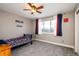 Bright bedroom featuring a ceiling fan and a window with charming red, white, and blue curtains at 3685 Roberts St, Mead, CO 80542