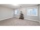 Well lit bedroom showcasing neutral walls, carpet, and two windows for natural light at 3685 Roberts St, Mead, CO 80542
