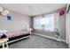 Cozy bedroom with a twin bed, bright window, and playful decor for a cheerful and inviting space at 3685 Roberts St, Mead, CO 80542