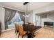 Dining room featuring large window, modern chandelier and wood table at 3685 Roberts St, Mead, CO 80542