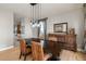 Well-lit dining room with a wooden table, chairs and elegant buffet at 3685 Roberts St, Mead, CO 80542