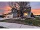 Two-story home with a three-car garage, stone accents, manicured lawn and landscaping at 3685 Roberts St, Mead, CO 80542