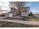 Well-manicured lawn with mature trees and a long driveway on a sunny day at 3685 Roberts St, Mead, CO 80542