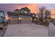 Beautiful two-story home featuring a three-car garage and modern architectural details at sunset at 3685 Roberts St, Mead, CO 80542