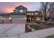 Charming two-story home with stone accents, three-car garage, and manicured front yard under a colorful evening sky at 3685 Roberts St, Mead, CO 80542