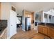 Modern kitchen with stainless steel refrigerator leading into the staircase at 3685 Roberts St, Mead, CO 80542
