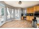 Bright kitchen featuring hardwood floors, a built-in desk, and many windows with natural light at 3685 Roberts St, Mead, CO 80542