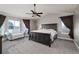 Spacious main bedroom featuring a dark wood bed frame, ceiling fan, and large windows with beautiful outdoor views at 3685 Roberts St, Mead, CO 80542