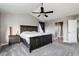A cozy main bedroom with a ceiling fan, dark wood furniture, and soft lighting, creating a relaxing atmosphere at 3685 Roberts St, Mead, CO 80542