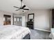 Comfortable main bedroom with a ceiling fan, dark wood furniture, and access to an en-suite bathroom and hallway at 3685 Roberts St, Mead, CO 80542