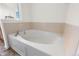 Relaxing corner soaking tub with tiled surround, perfect for unwinding after a long day at 3000 E 112Th Ave # 86, Northglenn, CO 80233