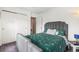 Bedroom with a comfy bed, patterned comforter, and a charming stuffed animal at 3000 E 112Th Ave # 86, Northglenn, CO 80233