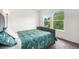 Bright bedroom featuring two sunny windows with views of lush greenery and trees at 3000 E 112Th Ave # 86, Northglenn, CO 80233