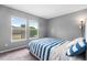 Bright bedroom with two windows offering natural light and street views at 3000 E 112Th Ave # 86, Northglenn, CO 80233
