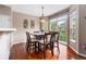 Cozy dining room featuring a large table, hardwood floors, and view of the neighborhood at 3000 E 112Th Ave # 86, Northglenn, CO 80233