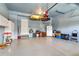 Spacious garage with epoxy floors, storage cabinets, overhead racks, and room for projects at 3000 E 112Th Ave # 86, Northglenn, CO 80233