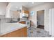 Efficient kitchen features laminate countertops, light wood cabinets, and laundry room access at 3000 E 112Th Ave # 86, Northglenn, CO 80233