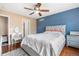 This main bedroom features a ceiling fan, a plush rug, and an ensuite bathroom at 3000 E 112Th Ave # 86, Northglenn, CO 80233