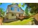 Well-maintained backyard featuring a wooden deck, lush green lawn, mature trees, and a privacy fence at 4788 Laurelglen Ln, Highlands Ranch, CO 80130