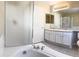 Well-lit bathroom with a soaking tub, glass shower, and double sink vanity at 4788 Laurelglen Ln, Highlands Ranch, CO 80130