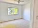 Neutral bedroom featuring soft carpet, large window, and freshly painted walls at 4788 Laurelglen Ln, Highlands Ranch, CO 80130