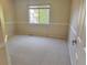 Neutral bedroom featuring soft carpet, large window, and freshly painted walls at 4788 Laurelglen Ln, Highlands Ranch, CO 80130