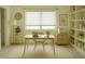 Serene home office featuring built-in shelving, a minimalist desk setup, and a window offering ample natural light at 4788 Laurelglen Ln, Highlands Ranch, CO 80130