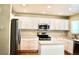 Kitchen featuring stainless steel appliances, white cabinets, kitchen island, and modern fixtures at 4788 Laurelglen Ln, Highlands Ranch, CO 80130