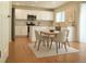 Bright kitchen with stainless steel appliances, a dining area, and hardwood flooring at 4788 Laurelglen Ln, Highlands Ranch, CO 80130