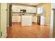 Kitchen featuring stainless steel appliances, white cabinets, kitchen island, and modern fixtures at 4788 Laurelglen Ln, Highlands Ranch, CO 80130