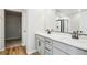 Bathroom with double vanity, a large mirror, and a shower visible in the reflection at 17942 E 94Th Pl, Commerce City, CO 80022